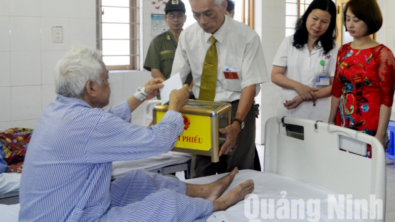 Các thành viên Tổ Bầu cử số 4, phường Bạch Đằng (TP Hạ Long) đưa hòm phiếu lưu động tới Bệnh viện Đa khoa tỉnh để cử tri thực hiện quyền bầu cử tại phòng bệnh. Ảnh: Hoàng Quý