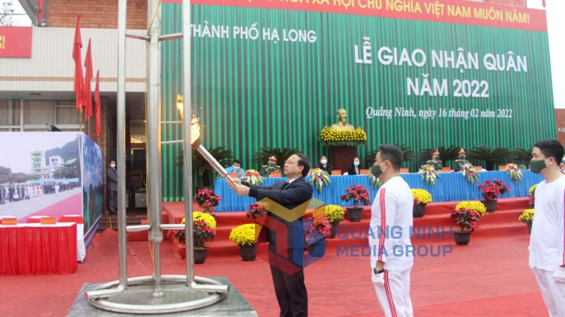 Bí thư Tỉnh ủy Nguyễn Xuân Ký thắp lửa truyền thống tại lễ giao nhận quân năm 2022 của TP Hạ Long (2-2022). Ảnh: Thu Chung