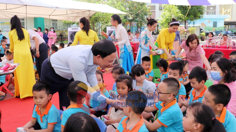 Đồng chí Bí thư Tỉnh ủy, Chủ tịch HĐND tỉnh tặng quà bánh cho các cháu thiếu nhi Trường Mầm non Hạ Long.

