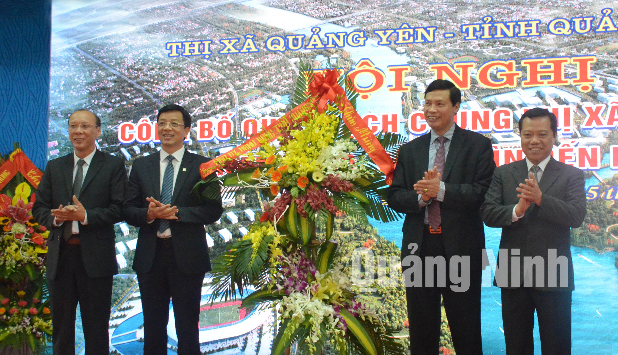 Đồng chí Nguyễn Đức Long, Phó Bí thư Tỉnh ủy, Chủ tịch UBND tỉnh tặng hoa chúc mừng TX Quảng Yên.
