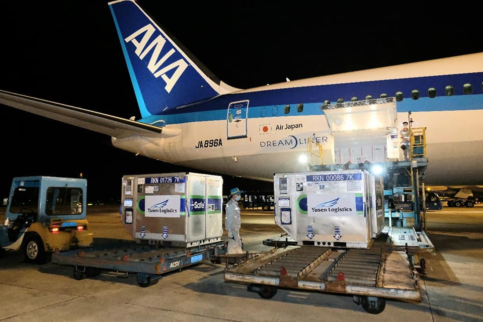 Containers with COVID-19 vaccine doses aided by Japan arrive at Noi Bai airport in Ha Noi on June 17, 2021.
