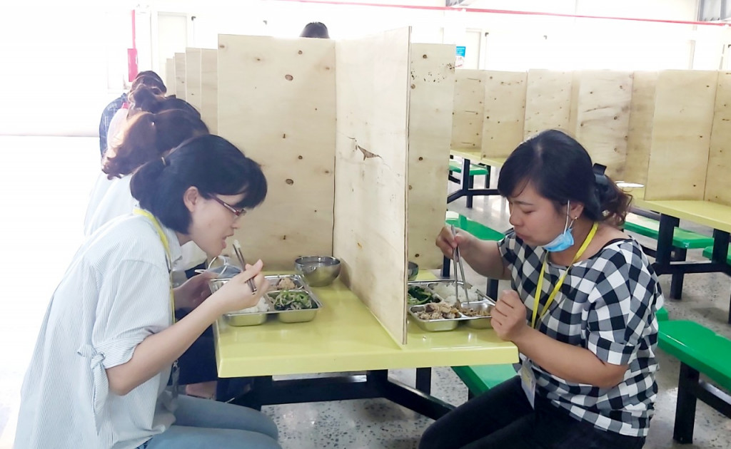 Giữa các bàn ăn cho CNLĐ của Công ty TNHH Dệt may Weitai đều bố trí vách ngăn phòng chống dịch.