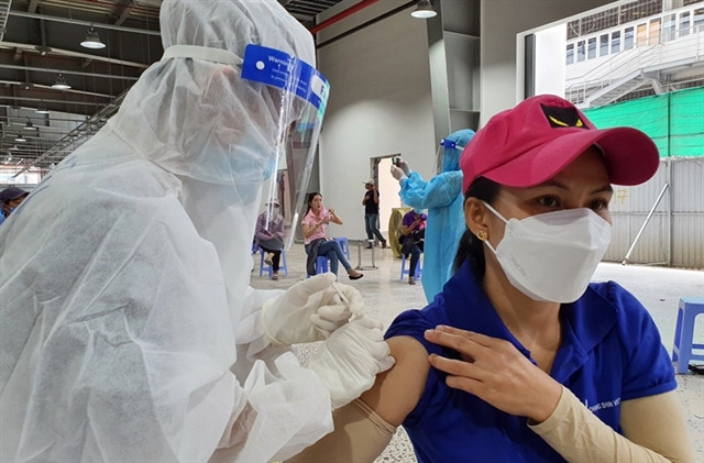 A factory worker in Đồng Nai gets a COVID vaccine jab. 