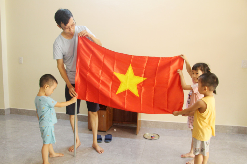 Gia đình anh Nguyễn Quang Khánh, khu 3, phường Hồng Hà đều về quê Thái Bình để thăm người thân trong ngày Quốc khánh nhưng năm nay anh quyết định ở lại Quảng Ninh. Để đón Tết độc lập, anh chuẩn bị cờ Tổ quốc để cùng các con treo lên ban công.