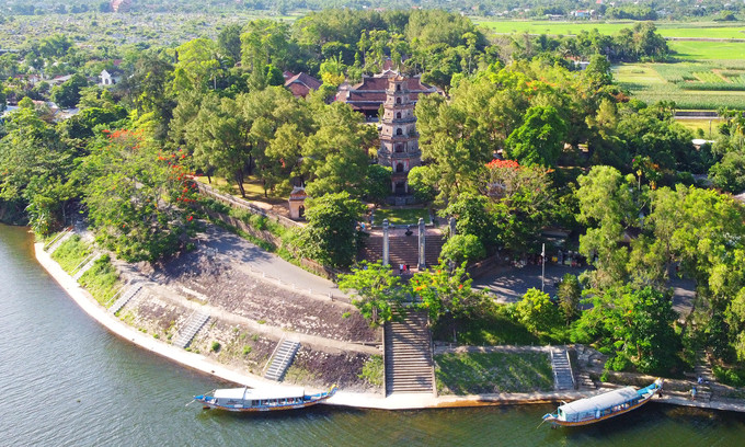 Boats dock in front of Thien Mu Pagoda by the iconic Huong (Perfume) River in Hue, 2020.