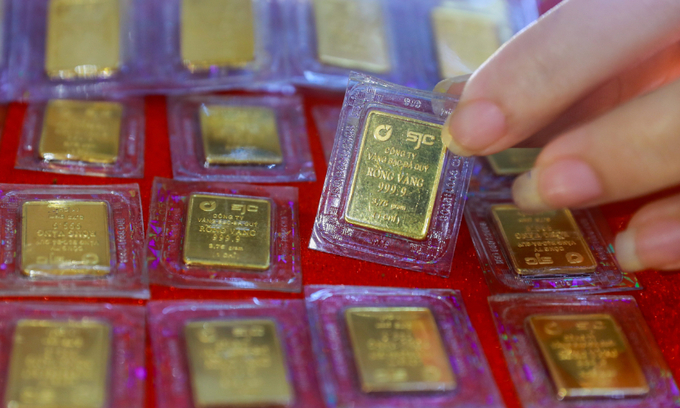 A person holds a tael of gold at a jewelry shop in Ho Chi Minh City. 