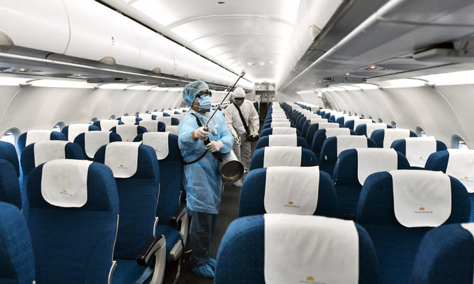 A person disinfects the inside of an aircraft. 