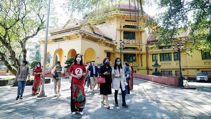 Visitors joining a tour to explore French architectural works in Hanoi.