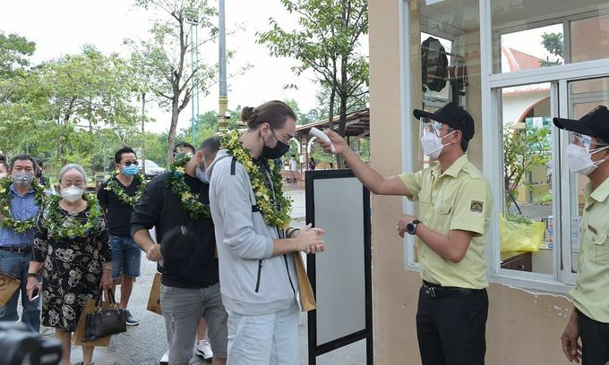 A staff of My Son Sanctuary in Quang Nam Province checks foreign tourists' body.