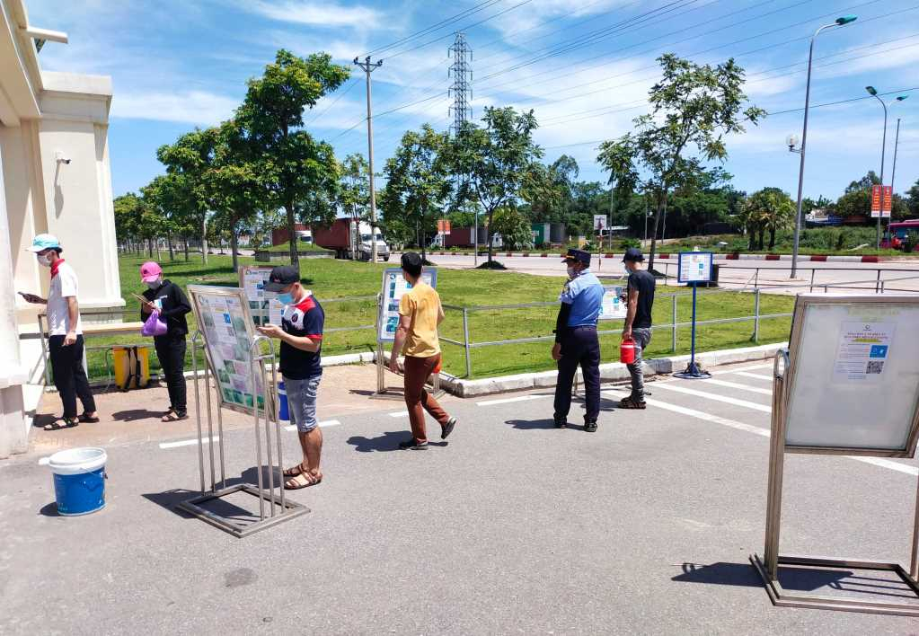 Workers scan QR code prior to entering the industrial park.