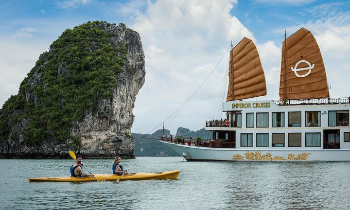 Foreign tourists sail kayak on Ha Long Bay, Quang Ninh Province. Photo courtesy of Lux Group.
