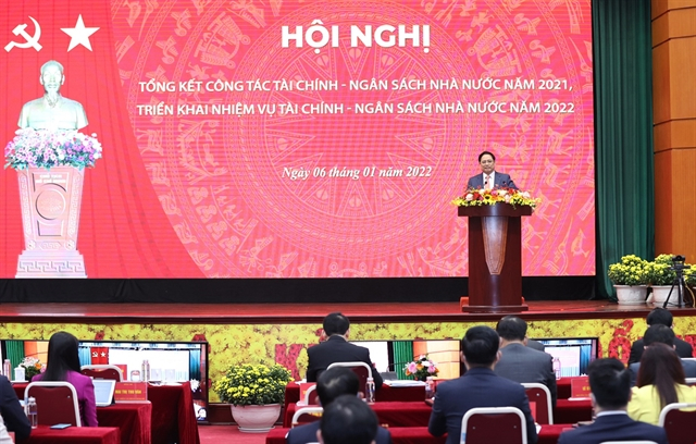 Prime Minister Phạm Minh Chính speaks to participants at a conference discussing Việt Nam's fiscal and financial policies for 2022.