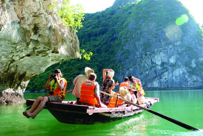 Foreign tourists visit Ha Long Bay.