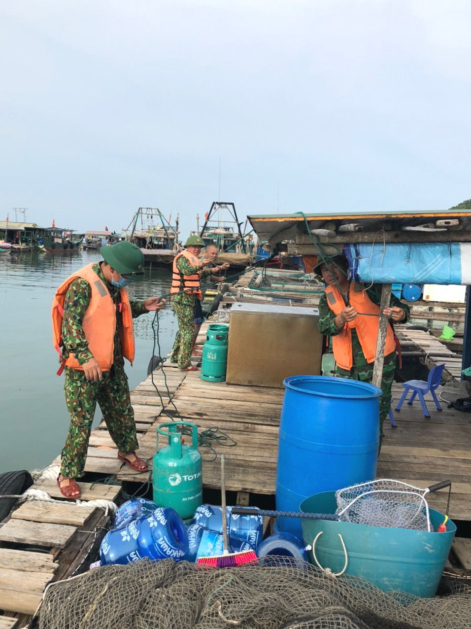 CBCS Đồn Biên phòng cửa khẩu cảng Vạn Gia (BĐBP tỉnh) giúp ngư dân tại khu vực biển Cống Cách (xã đảo Vĩnh Trung, TP Móng Cái) neo buộc lồng bè nuôi trồng thủy sản.