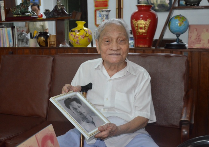 Cụ Nguyễn Thọ Chân xem lại bức ảnh của mình do mật thám Pháp chụp khi cụ bị bắt năm 1943.