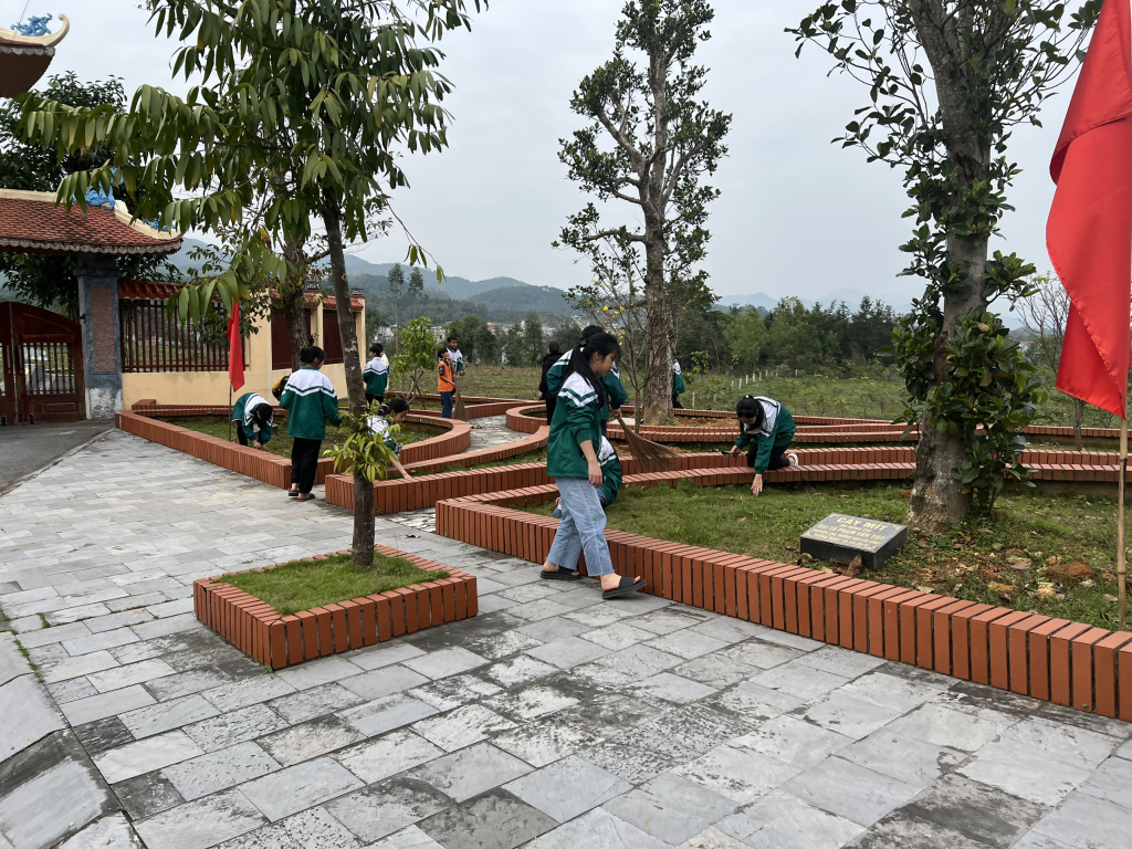 Các cháu học sinh nhặt cỏ, dọn rác khuôn viên khu di tích