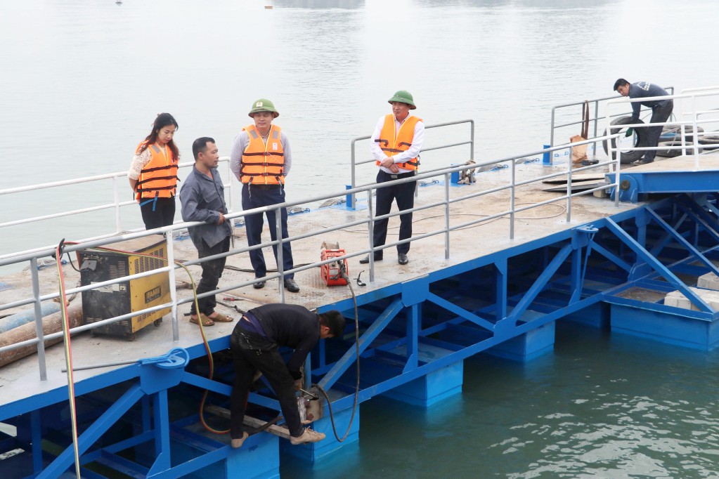 Các đồng chí lãnh đạo Huyện ủy, UBND huyện kiểm tra tiến độ lắp đặt cầu phao nổi phục vụ tàu cỡ nhỏ tại cảng Ao Tiên. Ảnh: Ngân Hà (CTV)