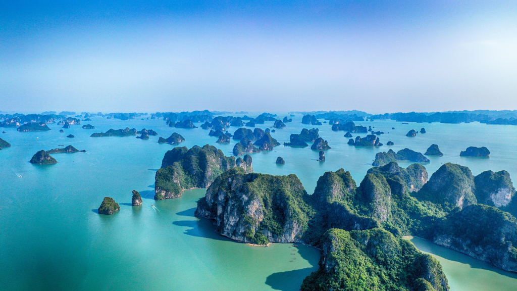 According to Condé Nast Traveler, Ha Long Bay is beloved for its blue waters and spread of limestone islands, all occupied by tropical trees and wildlife.