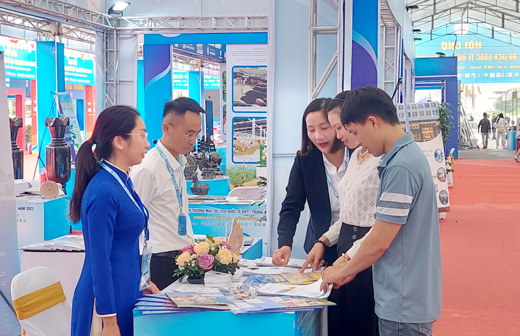 Người dân trao đổi thông tin về hoạt động thương mại qua biên giới tại Hội chợ Thương mại và Du lịch quốc tế Việt - Trung lần thứ 15 năm 2023 tại TP Móng Cái.