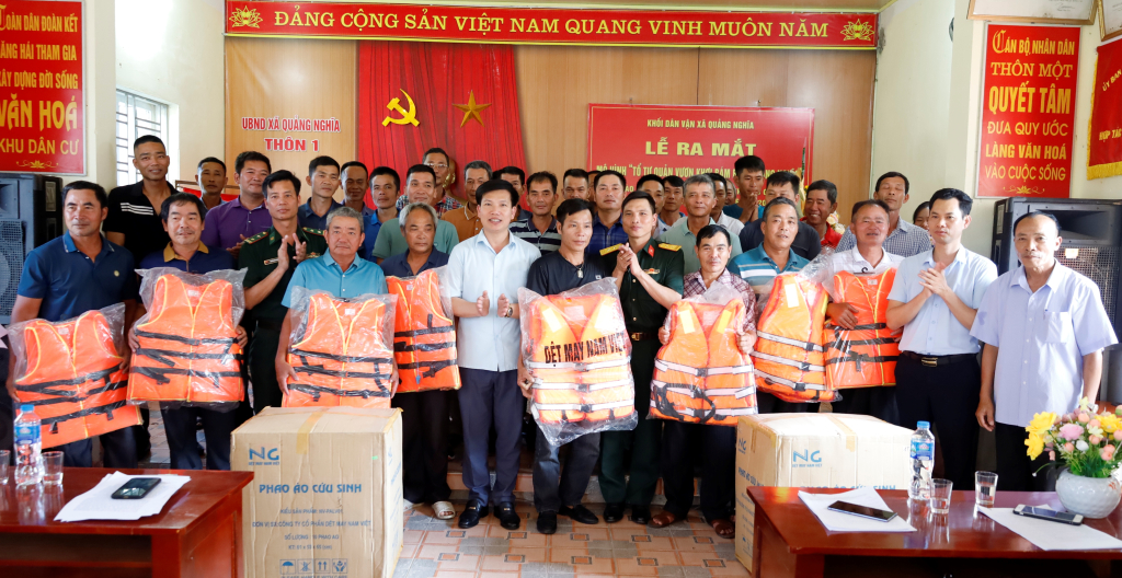 Trao tặng ảnh Bác Hồ, cờ Tổ Quốc và áo phao cho thành viên Tổ tự quản.