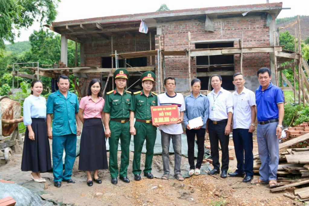 Lãnh đạo Ban CHQS thành phố Uông Bí, trao tiền hỗ trợ cho gia đình chiến sĩ Lý Văn Nhất.