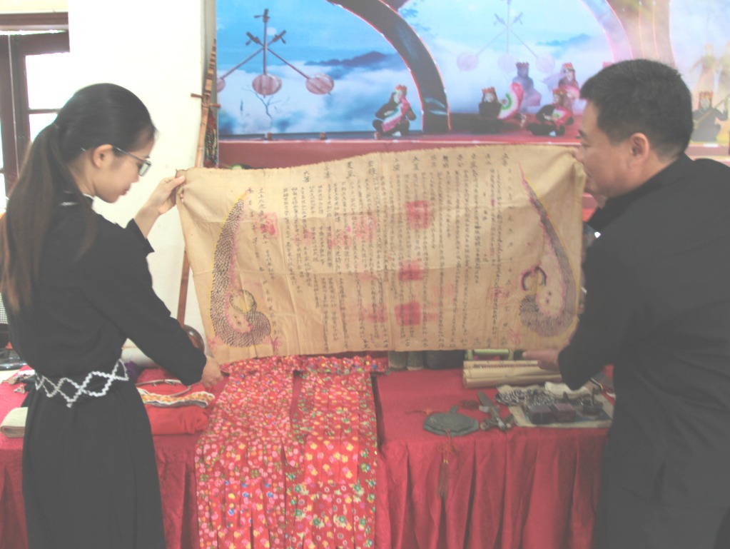 Một tờ sắc lệnh viết bằng chữ Nôm Tày trên giấy dó có những hoạ tiết giống như bức tranh.