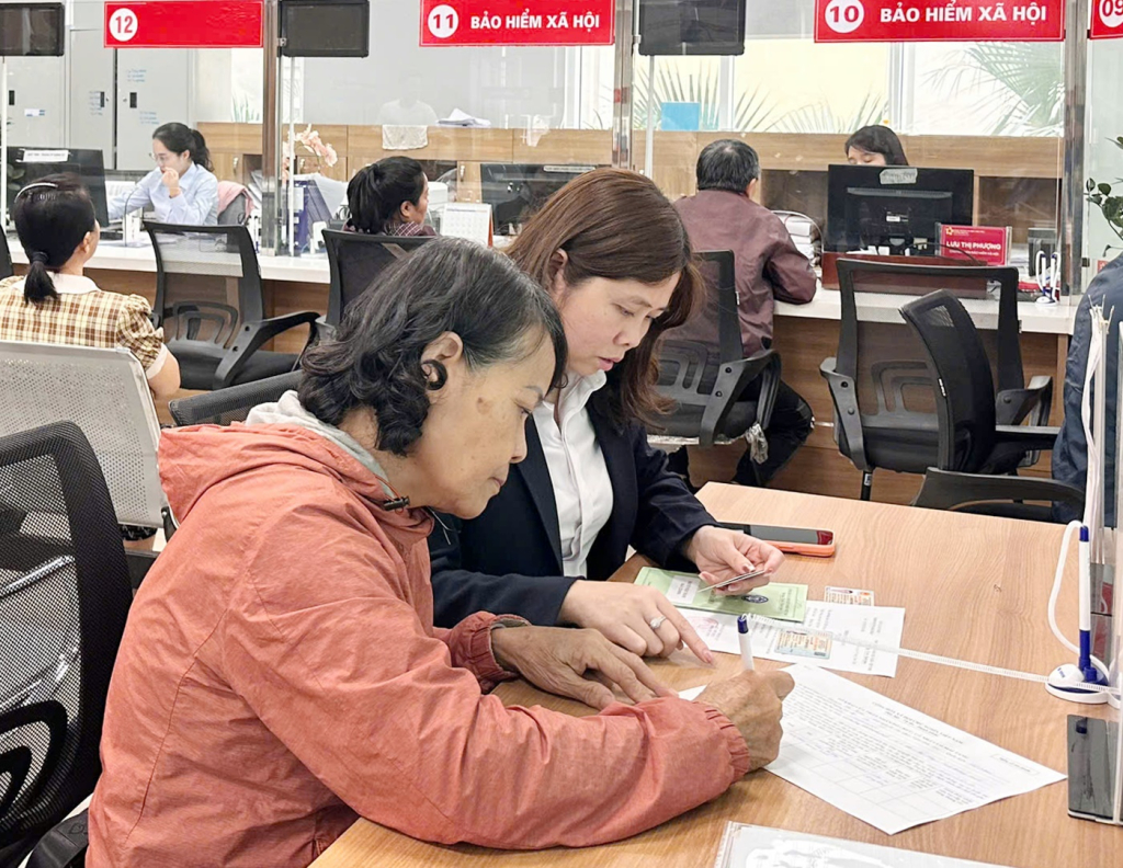 Cán bộ BHXH tỉnh hướng dẫn người dân giải quyết thủ tục liên quan BHXH, BHYT tại Trung tâm hành chính công phường Hồng Gai.