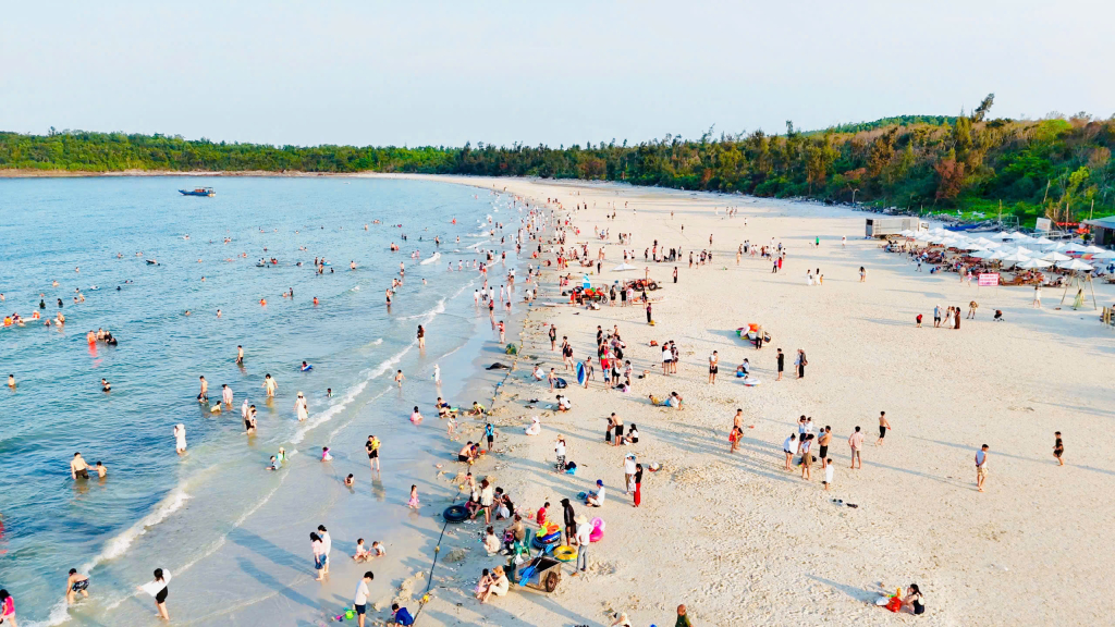Bãi biển Minh Châu đông vui với dòng người tắm biển, vui chơi.
